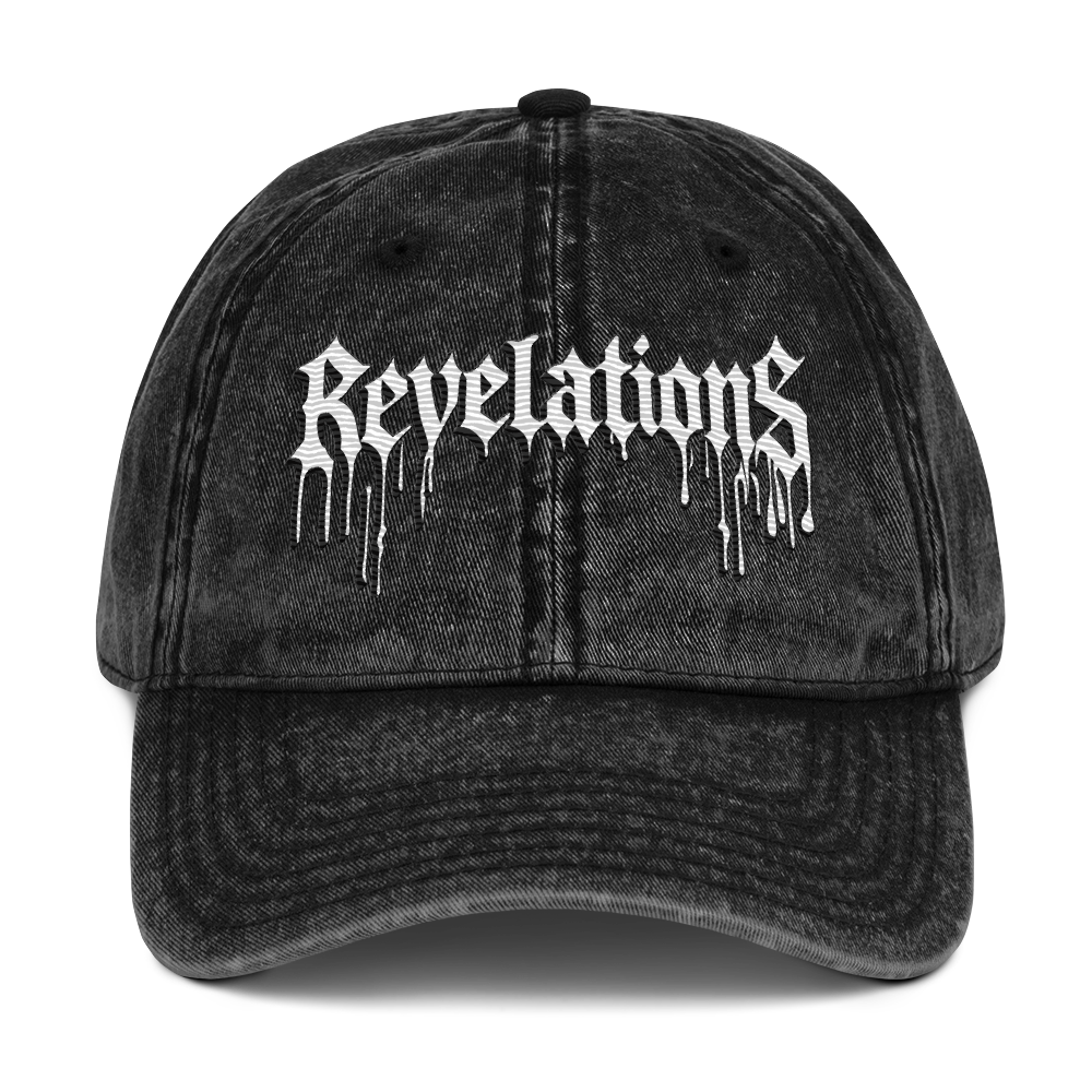Black vintage washed Ball Cap No.1 with white "Revelations" text, 100% cotton twill, metal snap buckle, and low-profile unstructured design.